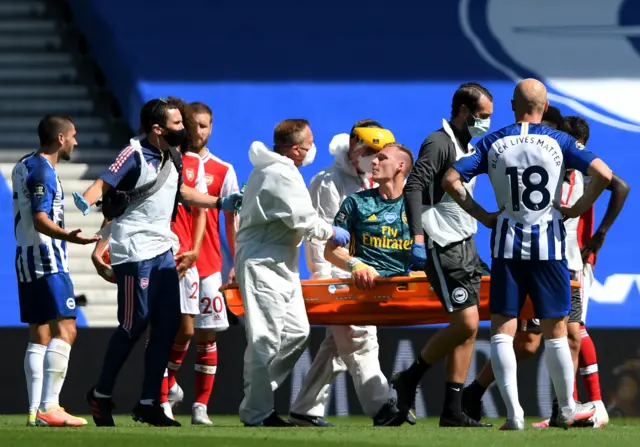 Bernd Leno of Arsenal shouts towards Neal Maupay of Brighton