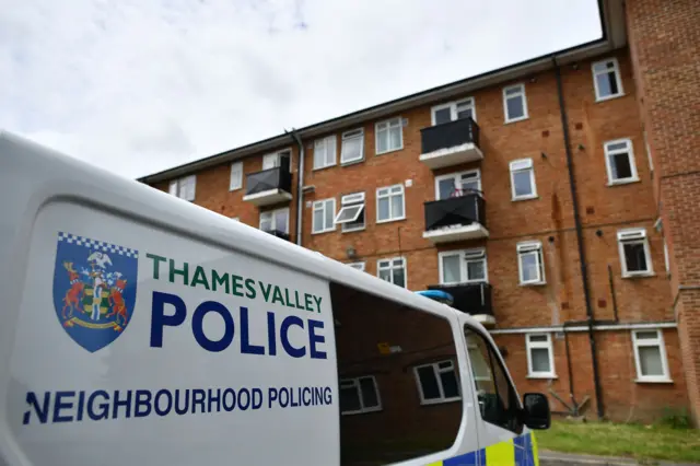 Police van outside flats in Reading