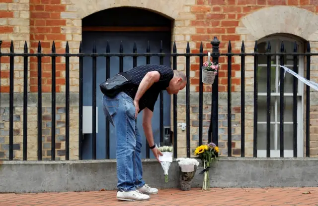 Man leaves flowers near stabbing scene in Reading