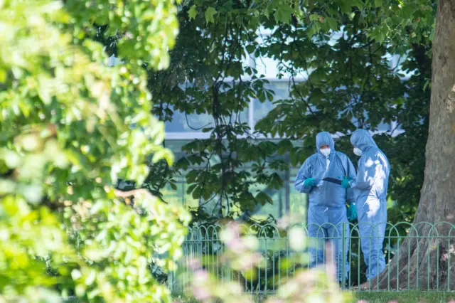 Forensic officers at the scene of the stabbings in Reading.