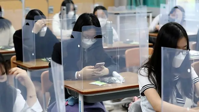 Pupils in Daejeon, South Korea, pictured in class last month