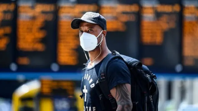 Man wearing face mask in train station