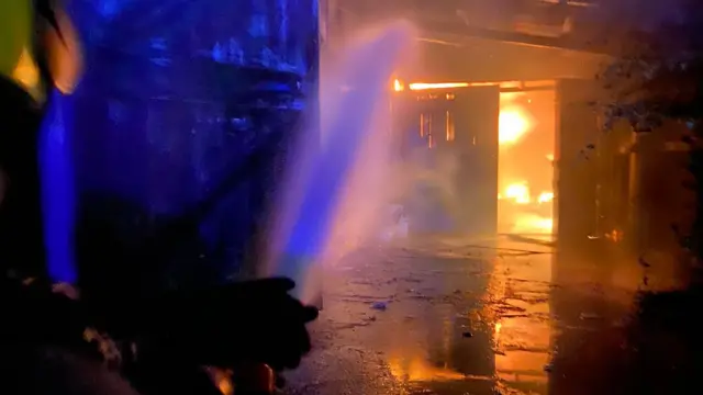 Hose putting water on fire