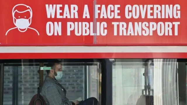 man in mask on bus