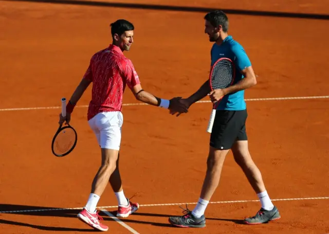 Serbia's Novak Djokovic greets Croatia's Marin Cilic against Germany's Alexander Zverev and Croatia's Borna Coric