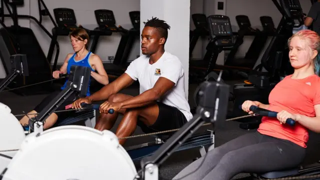 People using indoor rowing machines