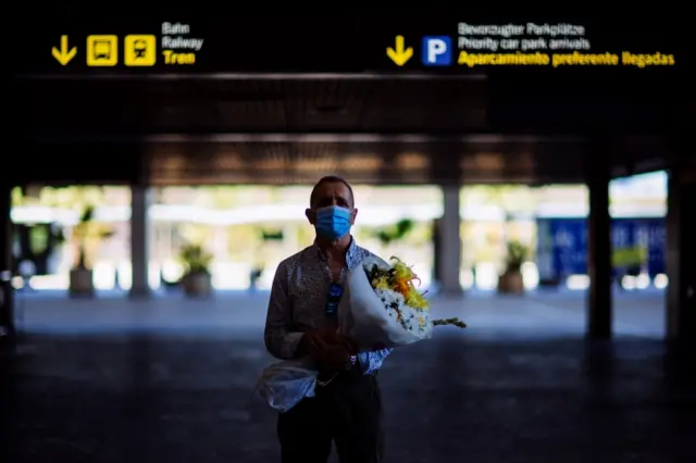 A man waits for a traveller at Malaga airport, Spain, on 22 June 2020