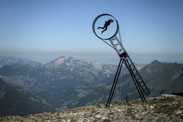 Swiss acrobat Ramon Kathriner performs with the Wheel Of The Death during the Glacier 3000 Air show an event