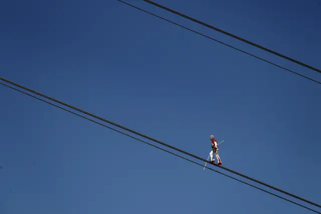 Swiss acrobat Freddy Nock balances blindfolded on the carrying cable of a cable car during the "Glacier 3000" Air show, an event marking the reopening of the Alpine facilities on 23 June 2020 above Les Diablerets