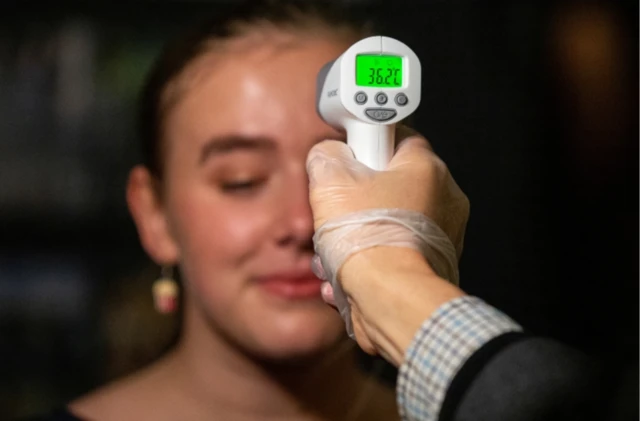 Woman has her temperature checked in Melbourne