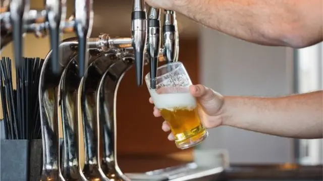 A pint being poured in a pub