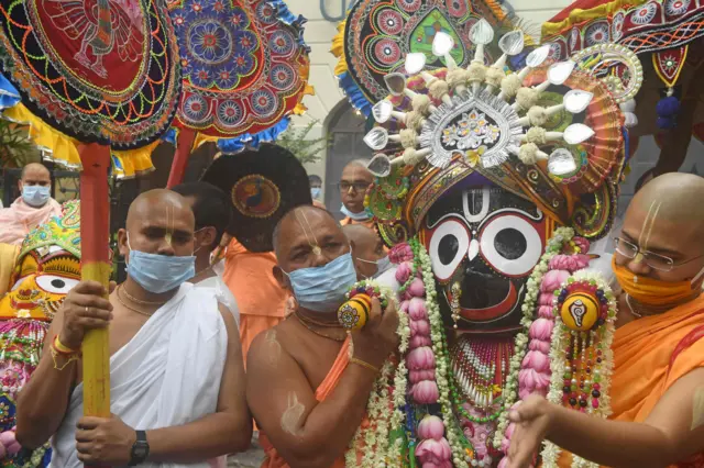 Temple priests and Hindu devotees carry an idol of Lord Jagannath in the Indian city of Kolkata