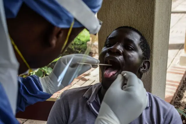 A medical officer takes a sample for the Covid-19 coronavirus at the laboratory of Kenya Medical Research Institute