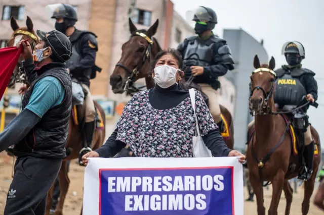 Members of the Peruvian Mounted Police disperse a group of textile businesspeople protesting for the prompt reactivation of textile activities in Lima on June 08, 2020