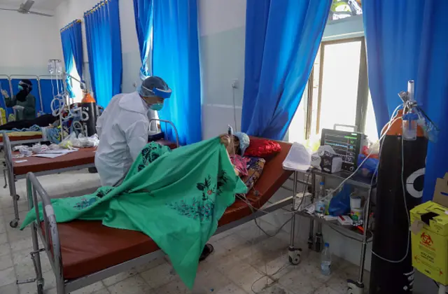 Yemeni members of the medical staff treat COVID-19 patients at a quarantine center in Yemen