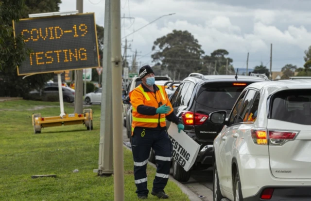 Queue of cars wait to enter a mobile Covid-19 testing site in a Melbourne suburb deemed a virus "hotspot"