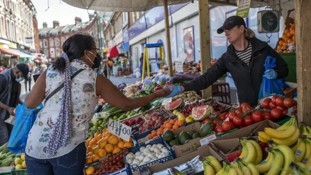 Woman paying for something at a market