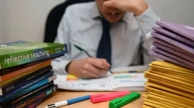 A teacher at a desk