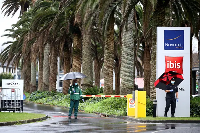 People stand outside a quarantine facility in New Zealand