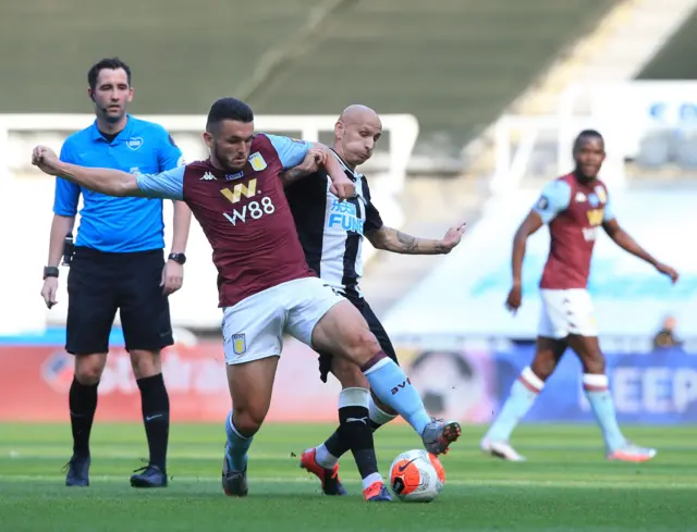 John McGinn (L) vies for the ball against Jonjo Shelvey