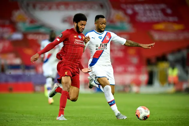 Joe Gomez (L) in action against Crystal Palace's Jordan Ayew