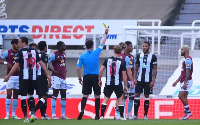 Douglas Luiz is shown a yellow card