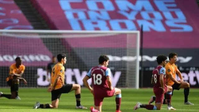 Wolves and West Ham players, take a knee before their game