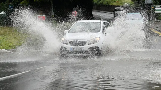 A car drives through flood water