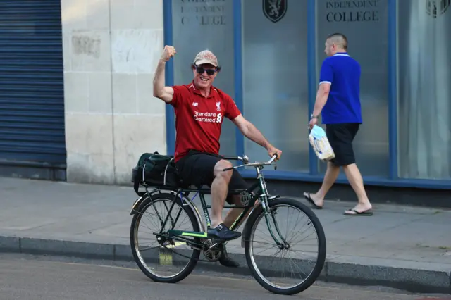 Liverpool fan on a bike outside Stamford Bridge