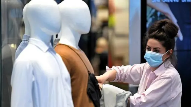 woman in shop with face mask