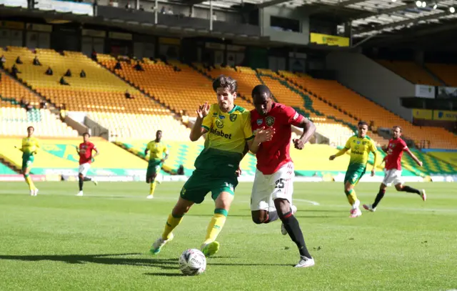 Norwich City's Timm Klose (left) and Manchester United's Odion Ighalo