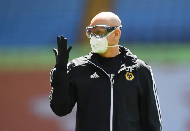 A member of Wolverhampton Wanderers staff wearing a protective face mask inside the stadium before the match