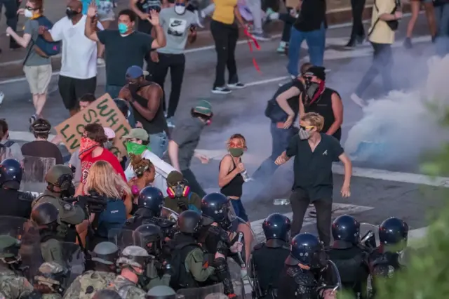 Police and National Guard move into protesters after curfew during a demonstration over the arrest in Minnesota of George Floyd