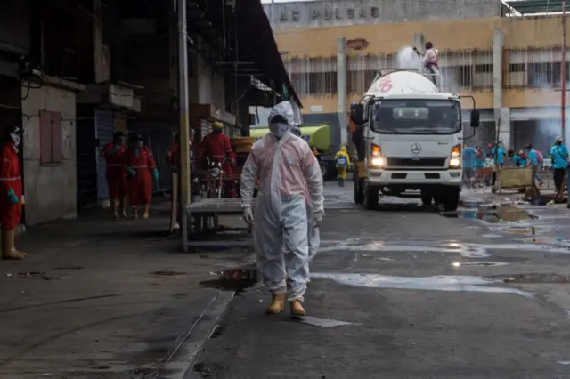 A man in Venezuela wears a hazmat suit