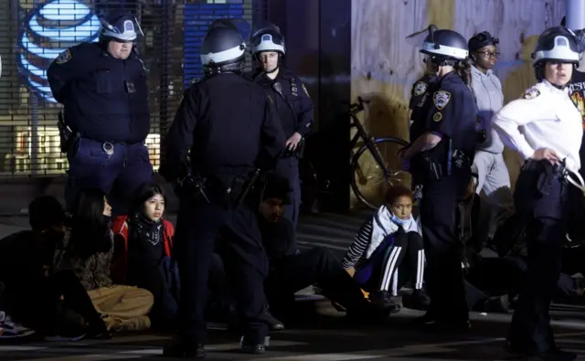 New York police stand over protesters arrested in the city