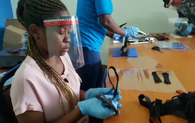 Workers prepare face shields from recycled plastics at the Zaidi Recyclers workshop as a measure to stop the spread of coronavirus in Dar es Salaam, Tanzania