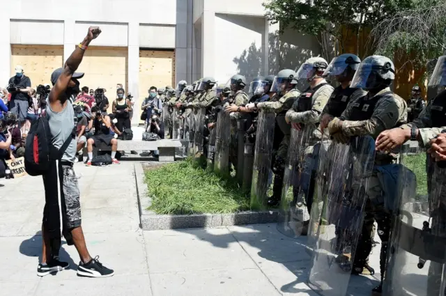 A protester faces off with military police near the White House on Wednesday