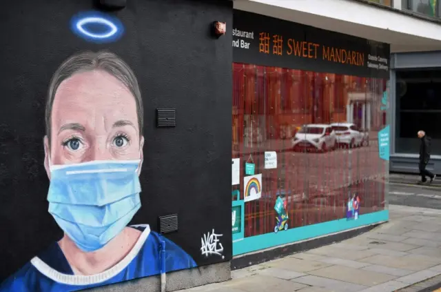 Street art showing a health worker in Manchester, UK