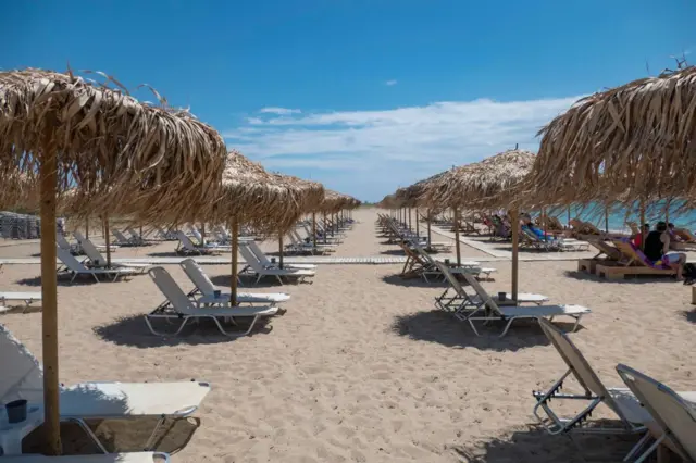 Sandy beach during a sunny day and Beach Bar at Nea Irakleia, Chalkidiki in Greece