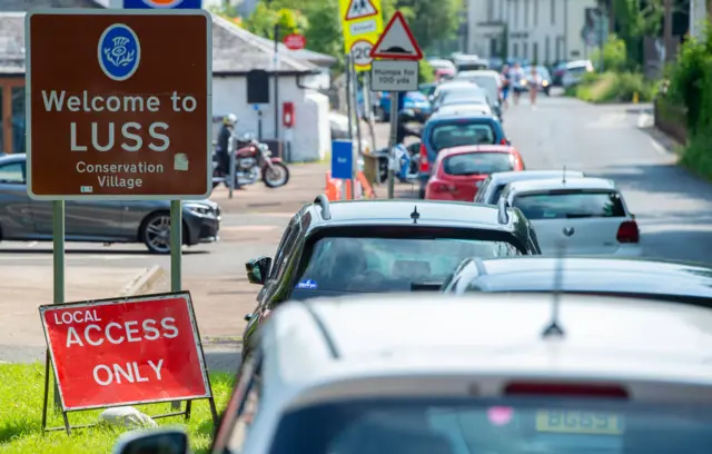 Cars parked on verges at Luss