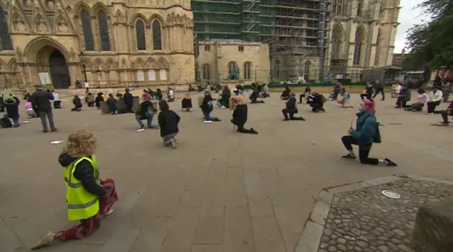 People kneeling outside York minster