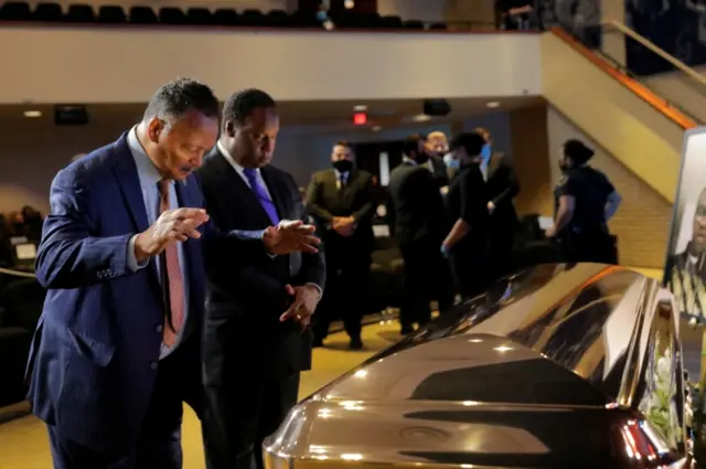 Civil rights campaigner Reverend Jesse Jackson prays in front of George Floyd's casket