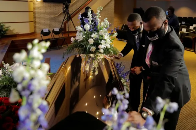 Men polish George Floydis casket before his memorial service following his death in Minneapolis police custody,