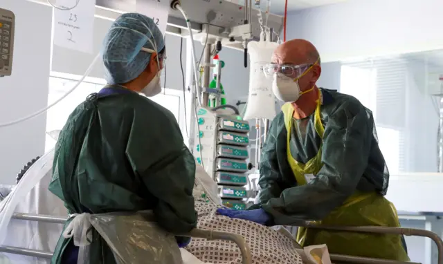 Medics at intensive care bed