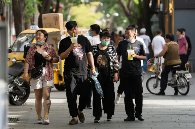 People walk in central Beijing