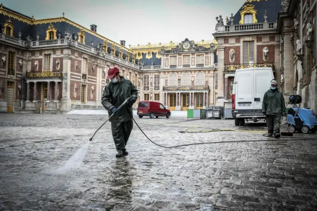 Employees clean the Palace of Versailles on the eve of its opening