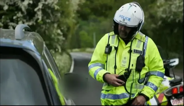 policeman speaking to motorist