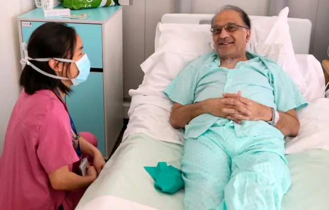 Doctor wearing mask while visiting patient