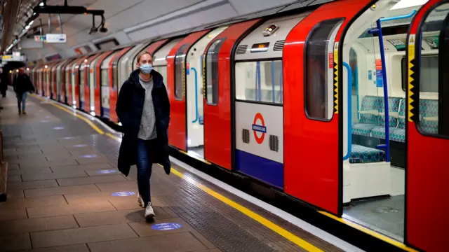 Person in mask in London Tube station