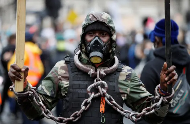 A demonstrator wearing a protective face mask during a Black Lives Matter protest in Parliament Square